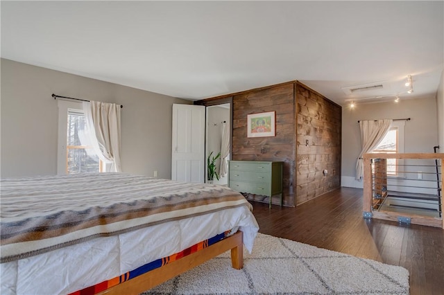 bedroom with hardwood / wood-style floors and visible vents