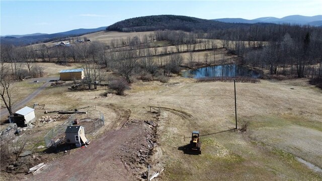 drone / aerial view featuring a water and mountain view