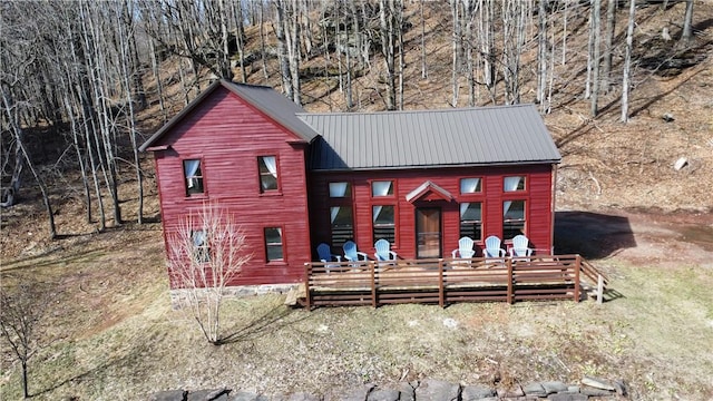 view of front of property featuring metal roof and a wooden deck