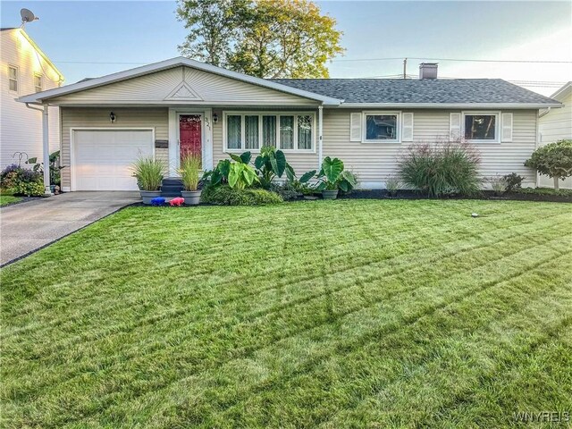 ranch-style home with aphalt driveway, an attached garage, a shingled roof, and a front lawn