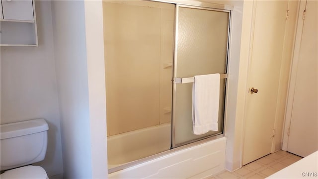 bathroom with tile patterned floors, toilet, and enclosed tub / shower combo