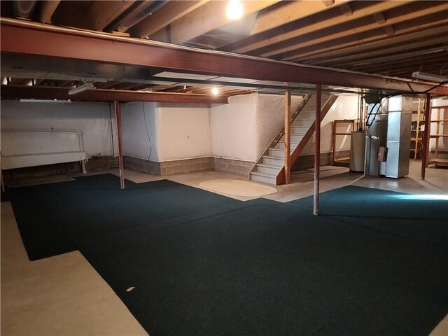 unfinished below grade area with heating unit and stairway