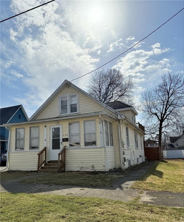 bungalow-style house with fence and entry steps