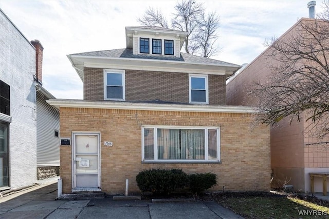 traditional style home featuring brick siding