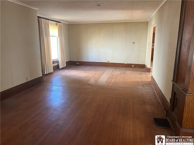 213 S Clinton St, Olean-City, NY 14760 - empty room with visible vents, wood finished floors, baseboards, and ornamental molding