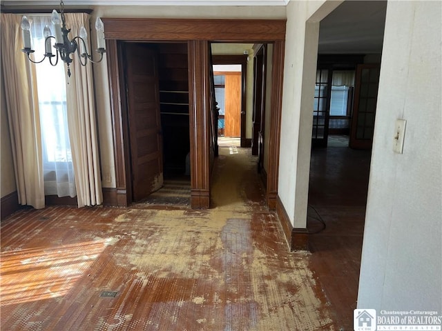 213 S Clinton St, Olean-City, NY 14760 - hallway featuring an inviting chandelier and wood finished floors