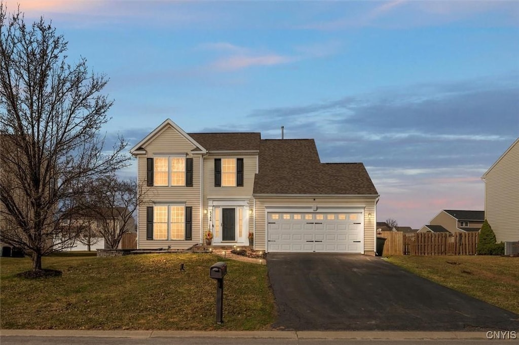 5544 Rockhampton, Clay, NY 13041 - traditional-style home featuring a front lawn, an attached garage, driveway, and fence