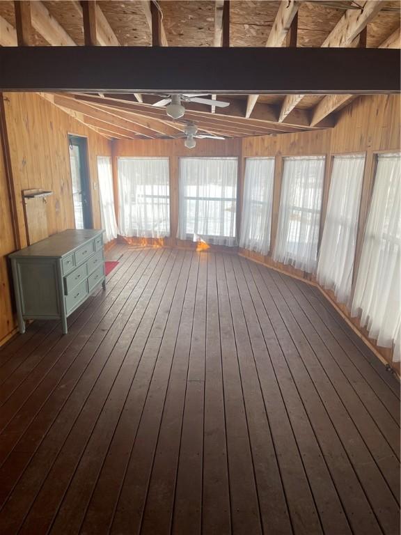 unfurnished sunroom with ceiling fan