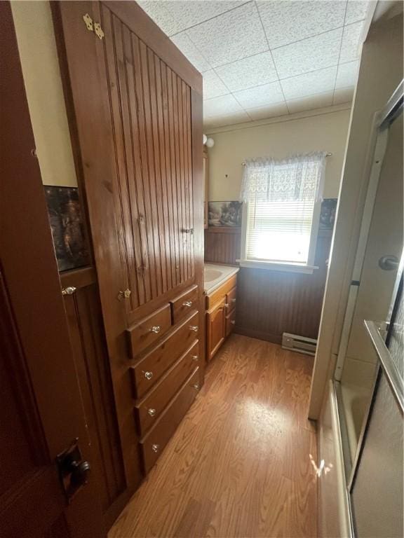 mudroom featuring light wood-style floors and a baseboard radiator