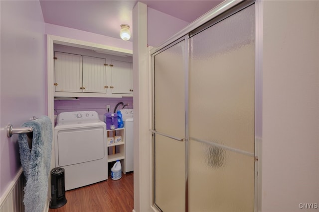 42913 County Route 100, Orleans, NY 13640 - laundry area with cabinet space, washer / clothes dryer, and wood finished floors