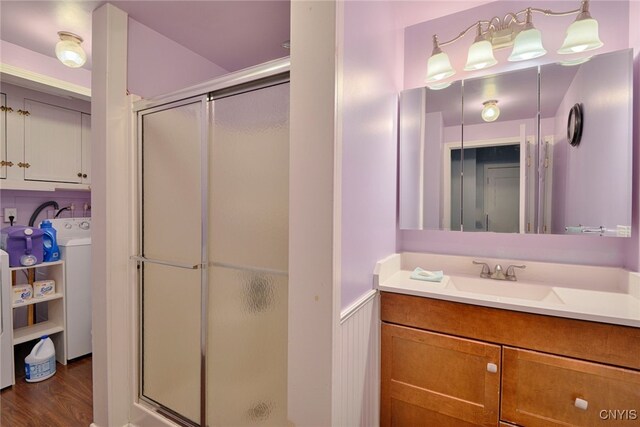 42913 County Route 100, Orleans, NY 13640 - full bath with a stall shower, washer / dryer, wood finished floors, and vanity