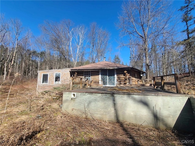 rear view of house featuring log exterior