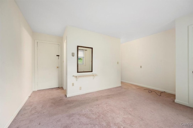 carpeted empty room with baseboards