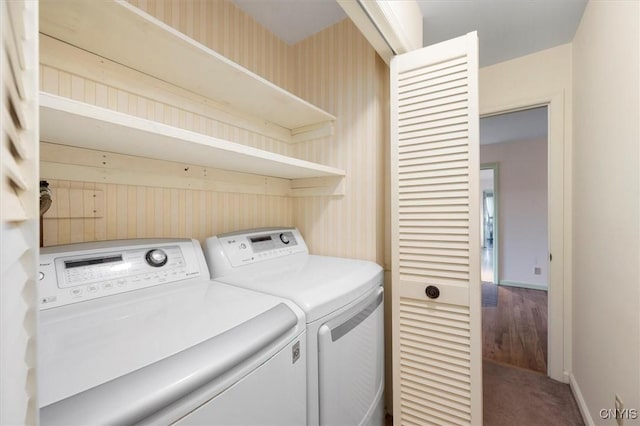 laundry room with wallpapered walls, baseboards, laundry area, carpet flooring, and separate washer and dryer