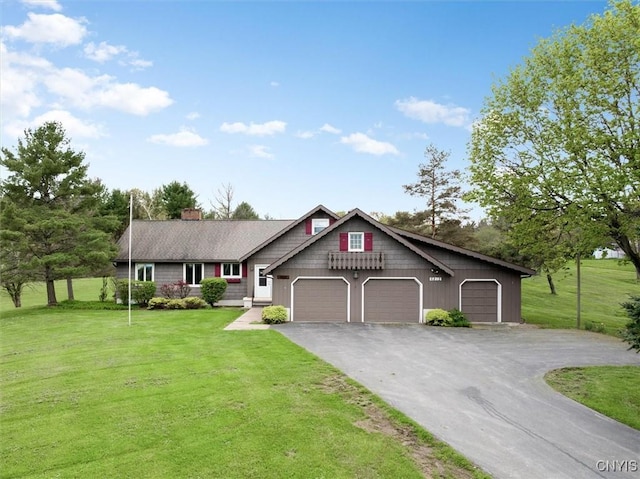 view of front of house with aphalt driveway, an attached garage, a chimney, and a front yard