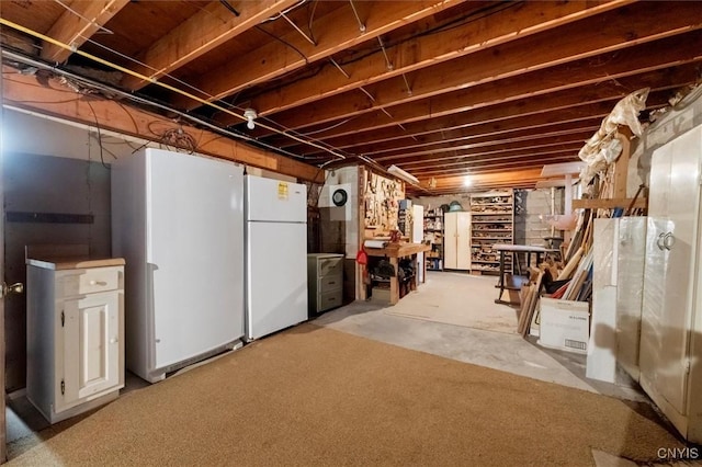 unfinished basement featuring freestanding refrigerator