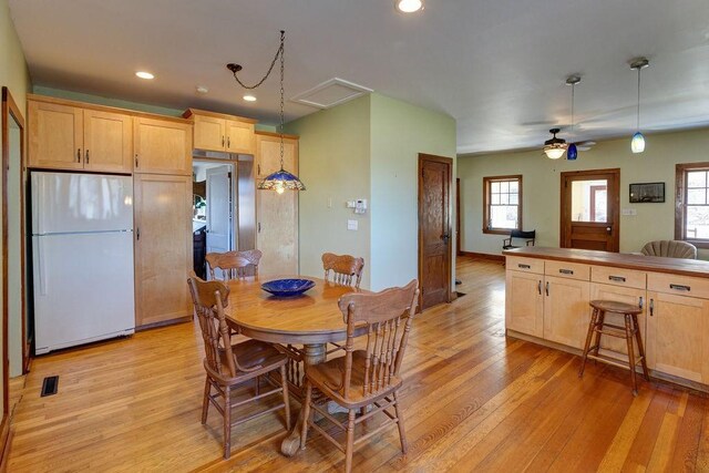 dining space with recessed lighting, baseboards, light wood finished floors, ceiling fan, and visible vents