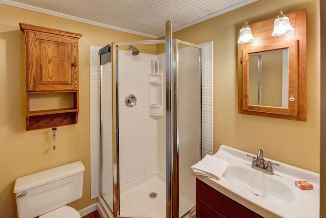 full bathroom featuring toilet, vanity, ornamental molding, and a stall shower