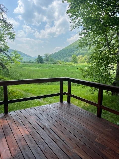 272 Arbor Hill Rd, Delhi, NY 13753 - wooden deck featuring a mountain view, a view of countryside, and a lawn
