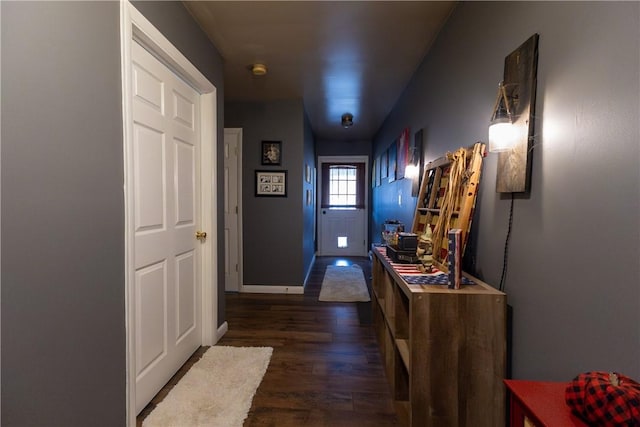 interior space featuring baseboards and dark wood-type flooring