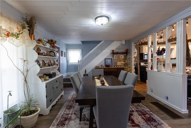 dining space featuring stairway and wood finished floors