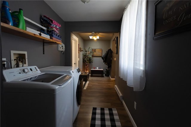 laundry area featuring dark wood-style floors, a baseboard radiator, laundry area, ceiling fan, and independent washer and dryer