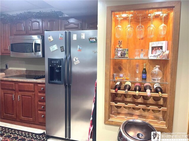 kitchen with light tile patterned floors and appliances with stainless steel finishes