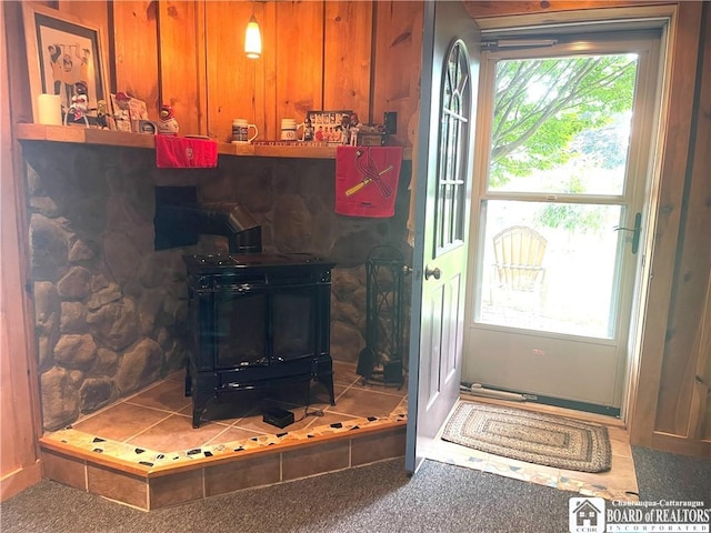 doorway to outside with a wood stove