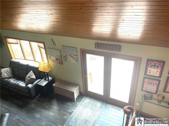 living area with wood ceiling, wood finished floors, visible vents, and a wealth of natural light