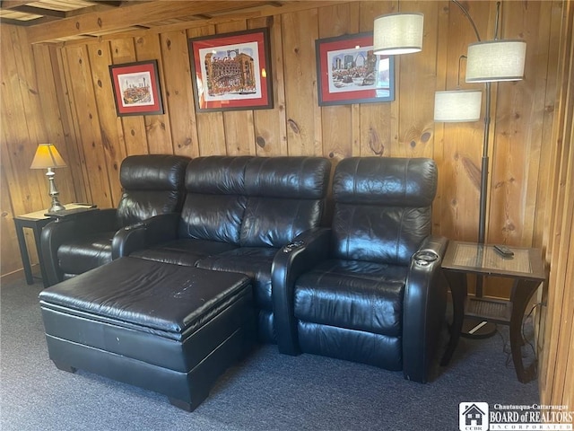 home theater featuring wood walls and carpet
