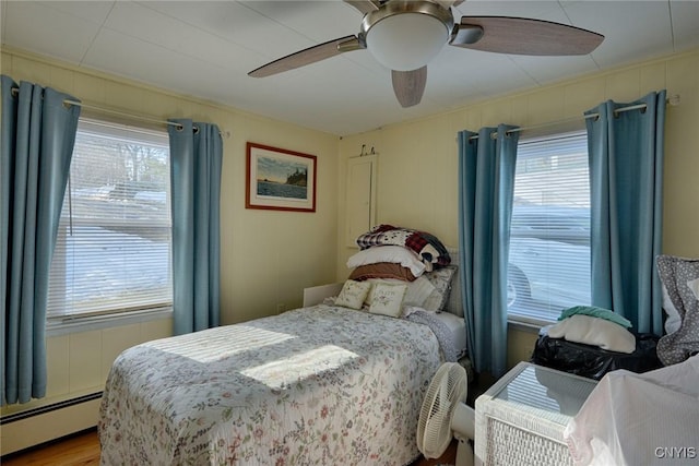21093 Cliff Ave, Alexandria, NY 13607 - bedroom featuring multiple windows, a baseboard heating unit, and a ceiling fan