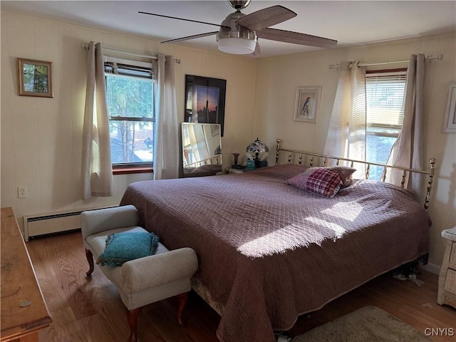 21093 Cliff Ave, Alexandria, NY 13607 - bedroom featuring a baseboard radiator, ceiling fan, and wood finished floors