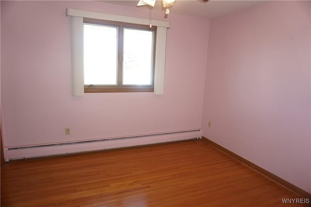 480 Lakeview Ave, Orchard Park, NY 14127 - empty room with baseboard heating, light wood-style floors, and baseboards