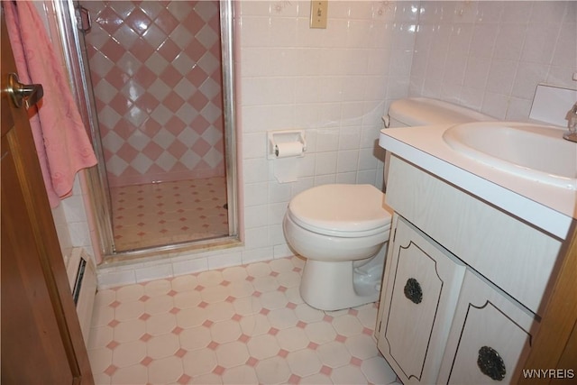 480 Lakeview Ave, Orchard Park, NY 14127 - bathroom with tile patterned floors, a stall shower, vanity, toilet, and tile walls
