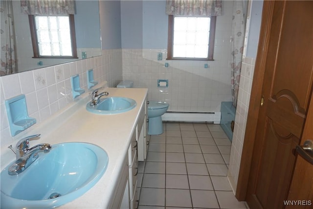 480 Lakeview Ave, Orchard Park, NY 14127 - bathroom with a baseboard heating unit, tile walls, tile patterned floors, toilet, and a wainscoted wall