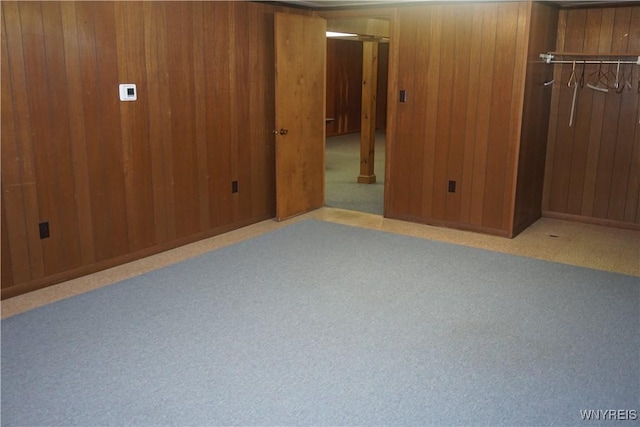 480 Lakeview Ave, Orchard Park, NY 14127 - unfurnished bedroom featuring a closet, wooden walls, and carpet flooring