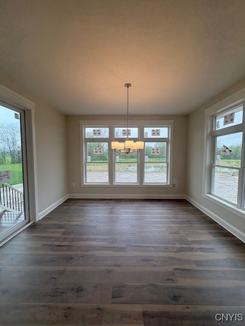 3515 Tall Tree Ln, Lysander, NY 13027 - unfurnished dining area featuring baseboards, a chandelier, plenty of natural light, and dark wood-type flooring