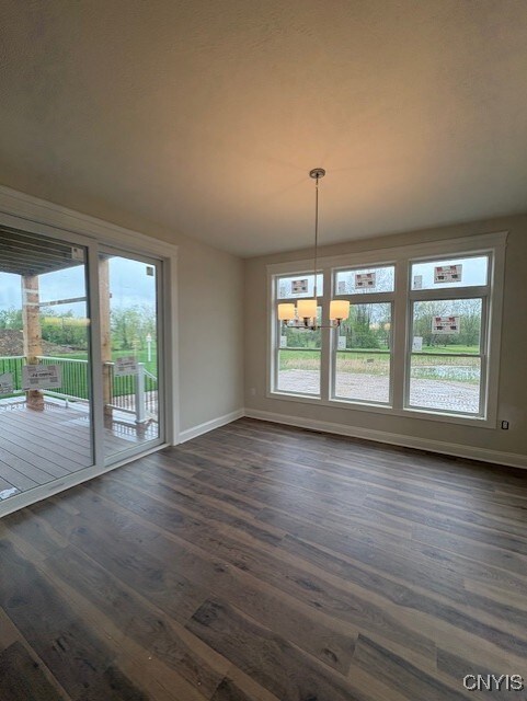 3515 Tall Tree Ln, Lysander, NY 13027 - unfurnished dining area with baseboards, a healthy amount of sunlight, and dark wood-style floors