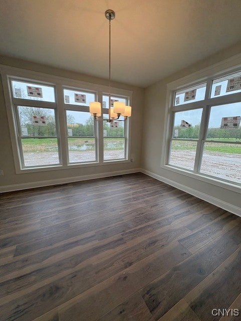 3515 Tall Tree Ln, Lysander, NY 13027 - unfurnished dining area featuring dark wood-style flooring, baseboards, and an inviting chandelier
