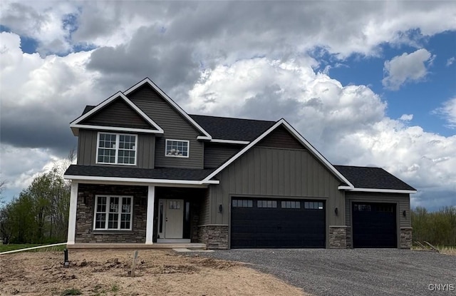 3515 Tall Tree Ln, Lysander, NY 13027 - craftsman-style house featuring a porch, stone siding, driveway, a garage, and board and batten siding