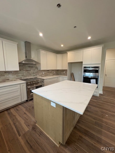 3515 Tall Tree Ln, Lysander, NY 13027 - kitchen featuring appliances with stainless steel finishes, white cabinets, and wall chimney exhaust hood