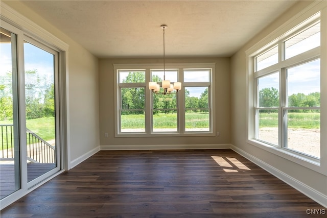 3515 Tall Tree Ln, Lysander, NY 13027 - unfurnished dining area featuring a chandelier, dark wood-style floors, and baseboards