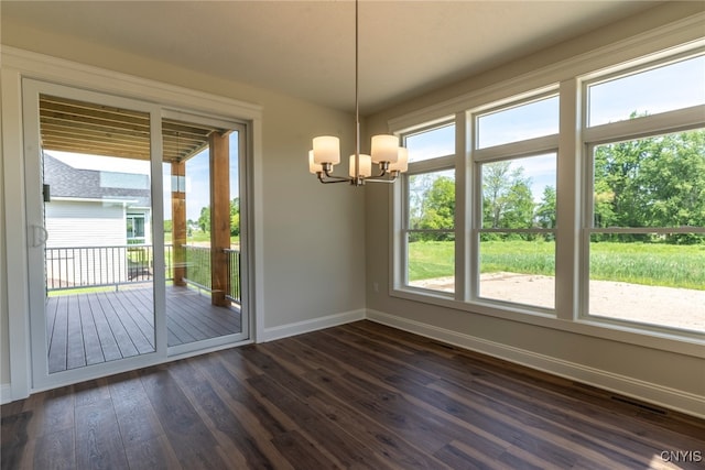 3515 Tall Tree Ln, Lysander, NY 13027 - unfurnished dining area with baseboards, a chandelier, healthy amount of natural light, and dark wood finished floors