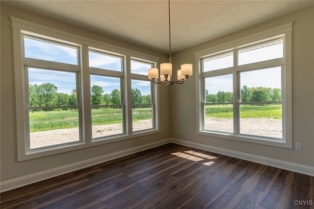 3515 Tall Tree Ln, Lysander, NY 13027 - spare room featuring a chandelier, baseboards, and dark wood finished floors