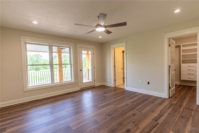 3515 Tall Tree Ln, Lysander, NY 13027 - unfurnished bedroom with dark wood-style floors, baseboards, a walk in closet, access to outside, and recessed lighting