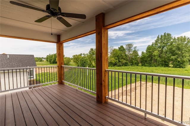 3515 Tall Tree Ln, Lysander, NY 13027 - wooden deck with ceiling fan, a lawn, and view of scattered trees