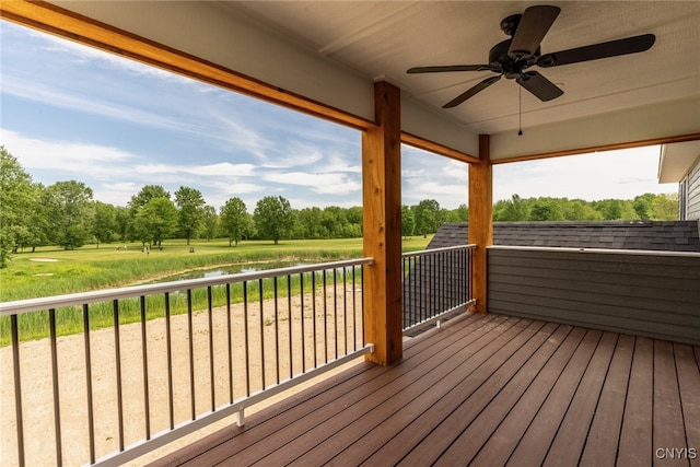 3515 Tall Tree Ln, Lysander, NY 13027 - wooden deck with a ceiling fan, view of scattered trees, and a water view