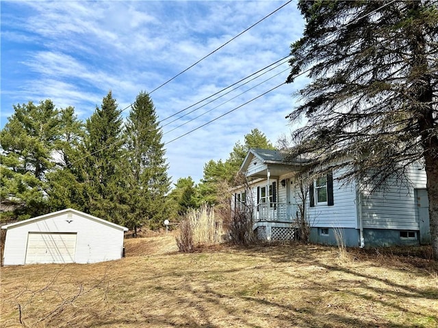 166 Backus Rd, New Lisbon, NY 13342 - view of yard featuring an outbuilding, a garage, and covered porch