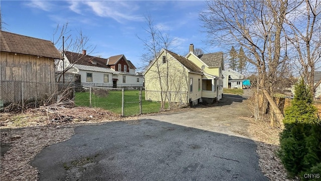 exterior space featuring driveway and fence