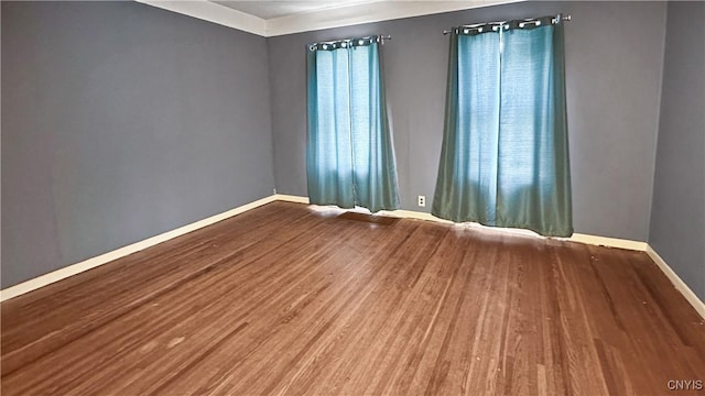 empty room with wood finished floors and baseboards